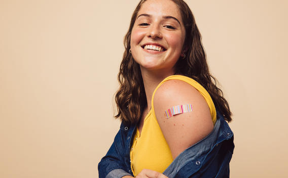 Mujer sonriendo después de recibir la vacuna COVID-19