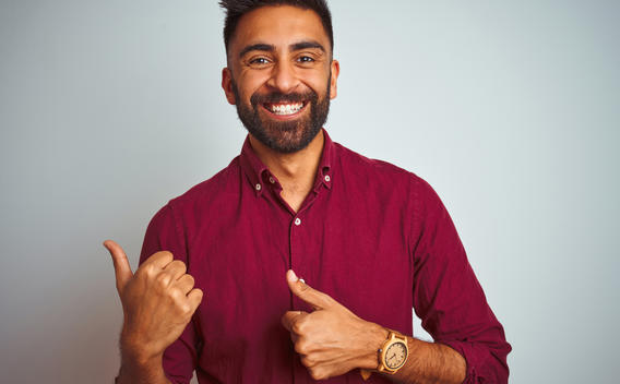Man smiling while making a presentation