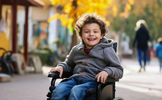 Niño en silla de ruedas, afuera durante el otoño