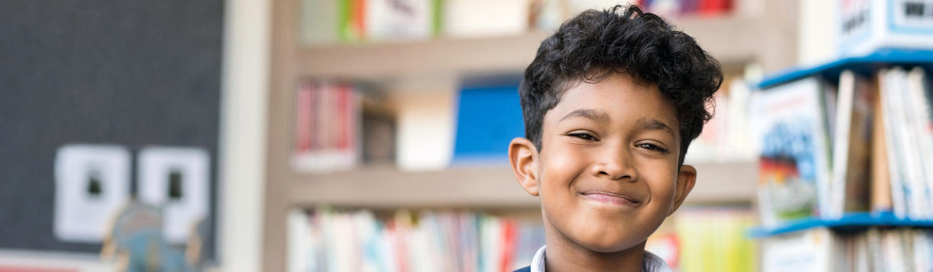 Male student smiling in library